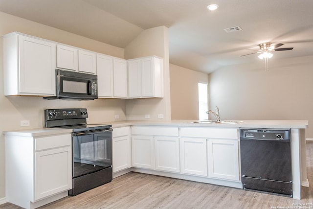 2340 Arctic Warbler, New Braunfels, TX 78130 - kitchen with black appliances, a sink, a peninsula, lofted ceiling, and light wood-style flooring