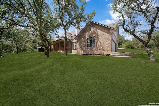 17451 Helotes Spgs, Helotes, TX 78023 - view of side of property featuring brick siding, a lawn, and a chimney