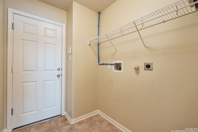 24931 Crescent Run, San Antonio, TX 78258 - laundry area featuring hookup for a washing machine, electric dryer hookup, light tile patterned flooring, and baseboards
