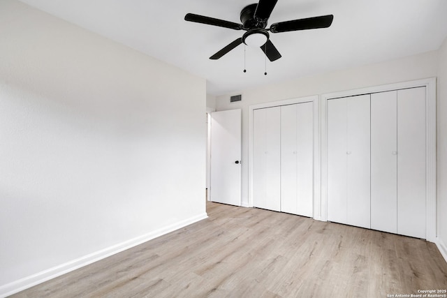246 Bamburgh Dr, San Antonio, TX 78216 - unfurnished bedroom with multiple closets, wood finished floors, baseboards, and ceiling fan