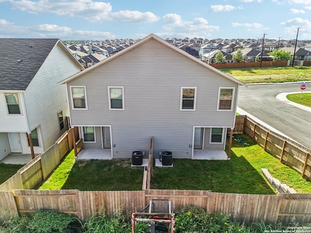 10203 Tulipwood Run, San Antonio, TX 78252 - back of house featuring a patio, a residential view, and central AC unit
