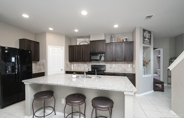 5727 Ivans Farm, San Antonio, TX 78244 - kitchen featuring black appliances, a sink, light tile patterned floors, dark brown cabinets, and recessed lighting