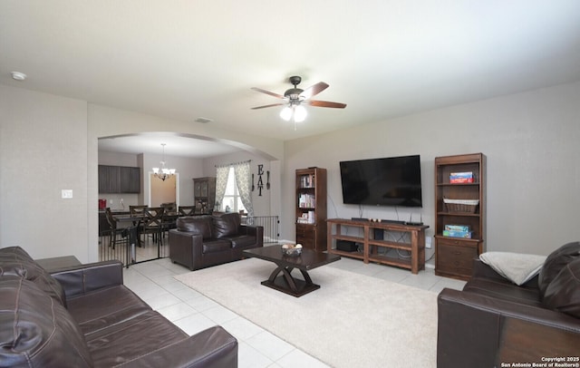5727 Ivans Farm, San Antonio, TX 78244 - living area featuring arched walkways, light tile patterned floors, ceiling fan, and a chandelier