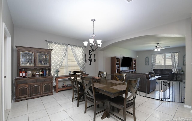 5727 Ivans Farm, San Antonio, TX 78244 - dining area with arched walkways, light tile patterned flooring, a ceiling fan, and a chandelier