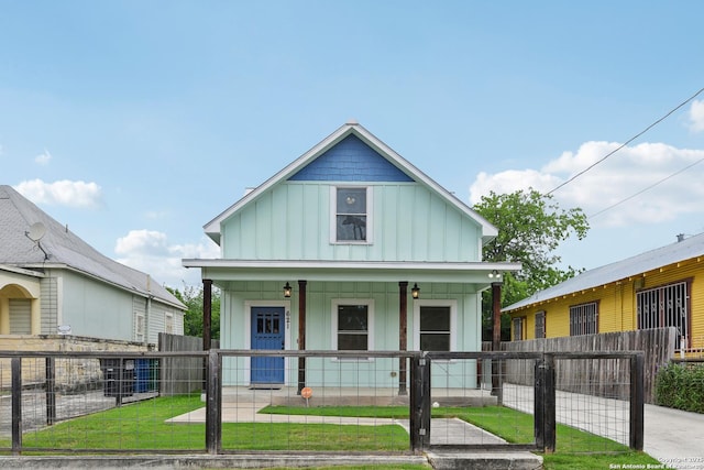 621 Center St, San Antonio, TX 78202 - view of front facade featuring board and batten siding, covered porch, and a gate