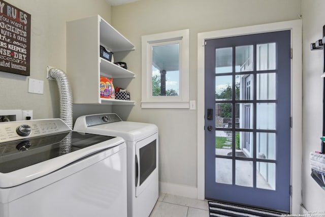 621 Center St, San Antonio, TX 78202 - laundry room featuring washing machine and dryer, light tile patterned floors, and baseboards