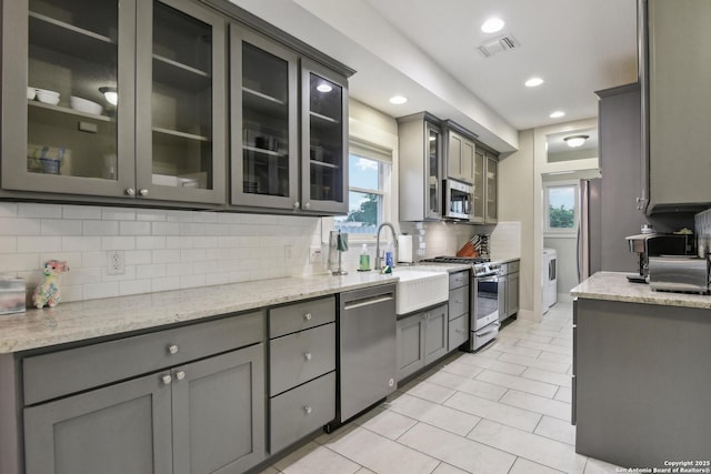 621 Center St, San Antonio, TX 78202 - kitchen featuring appliances with stainless steel finishes, decorative backsplash, gray cabinetry, a sink, and recessed lighting