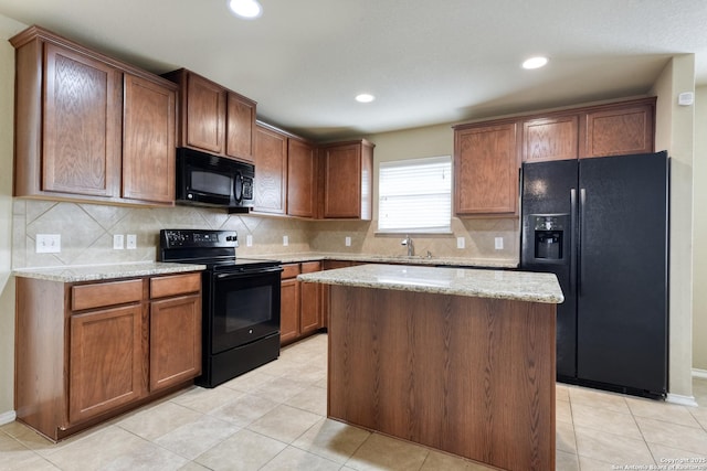 114 Arcadia Pl, Cibolo, TX 78108 - kitchen with black appliances, decorative backsplash, light stone countertops, a kitchen island, and recessed lighting