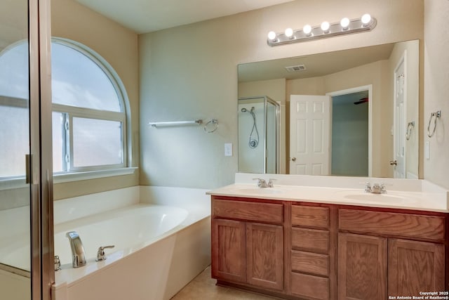 114 Arcadia Pl, Cibolo, TX 78108 - full bath featuring double vanity, a garden tub, a shower stall, and tile patterned flooring