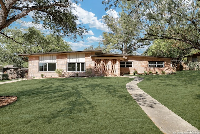 123 Riviera, Castle Hills, TX 78213 - mid-century inspired home featuring brick siding, a front yard, and board and batten siding
