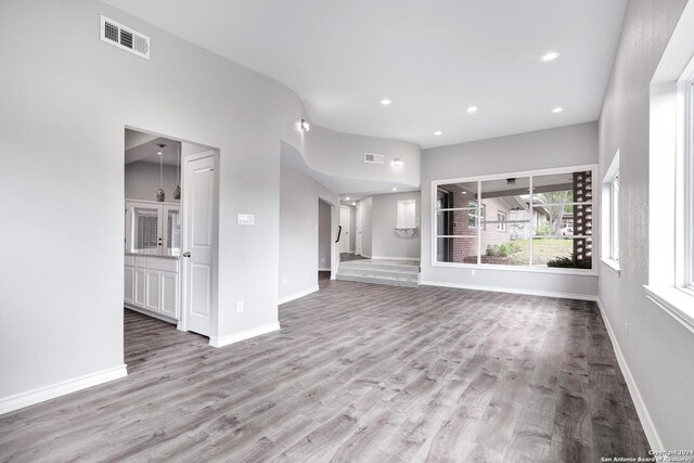 123 Riviera, Castle Hills, TX 78213 - unfurnished living room featuring wood finished floors, baseboards, and recessed lighting