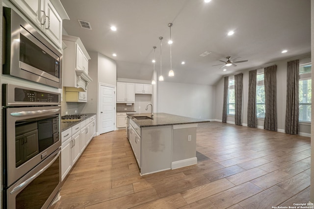 5847 Sweetwater, San Antonio, TX 78253 - kitchen with a sink, appliances with stainless steel finishes, open floor plan, ceiling fan, and dark stone countertops