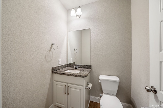 5847 Sweetwater, San Antonio, TX 78253 - half bath featuring vanity, toilet, baseboards, and wood finished floors