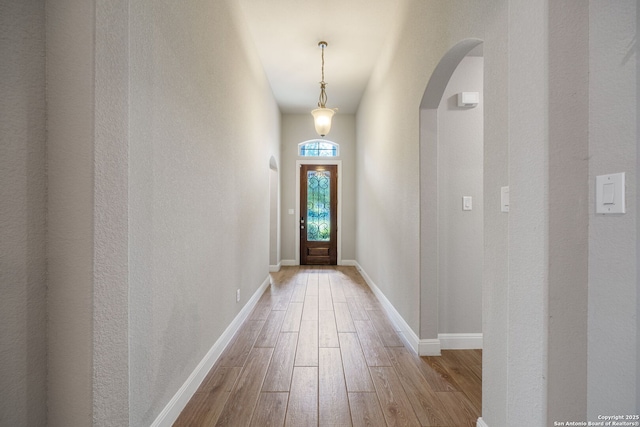 5847 Sweetwater, San Antonio, TX 78253 - doorway to outside featuring wood finished floors, arched walkways, and baseboards