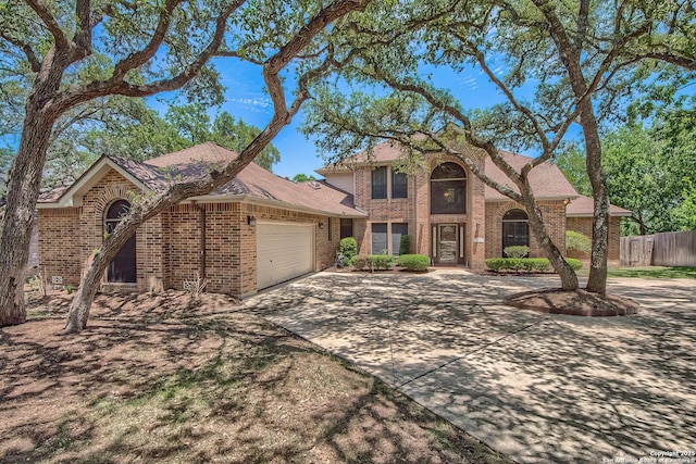 13742 Corinth, Universal City, TX 78148 - traditional-style house featuring brick siding, a garage, fence, and concrete driveway