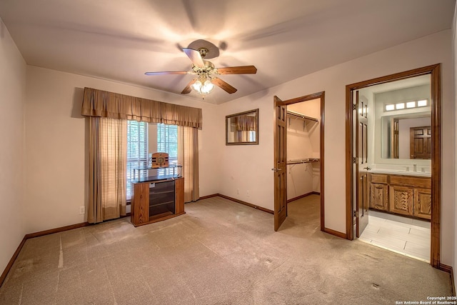 13742 Corinth, Universal City, TX 78148 - unfurnished bedroom featuring light colored carpet, baseboards, a spacious closet, ensuite bath, and a ceiling fan