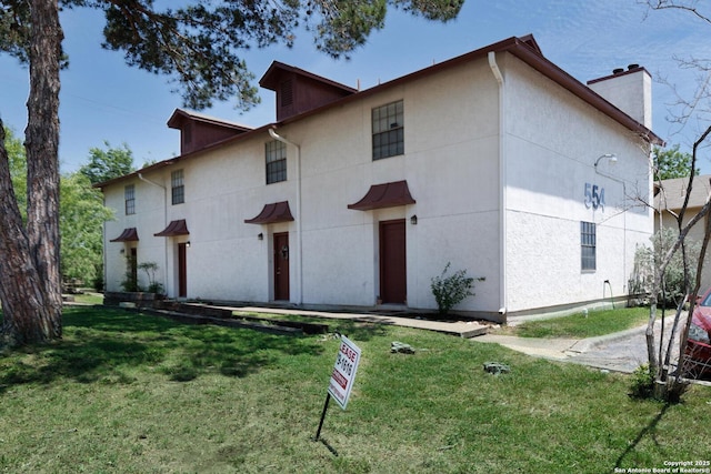 554 Dukeway, Universal City, TX 78148 - view of front facade featuring a front yard, a chimney, and stucco siding