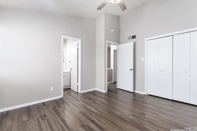 546 Dukeway, Universal City, TX 78148 - unfurnished bedroom featuring high vaulted ceiling, wood finished floors, a closet, baseboards, and ensuite bathroom