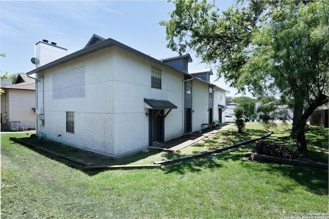 546 Dukeway, Universal City, TX 78148 - view of home's exterior featuring a lawn and a chimney
