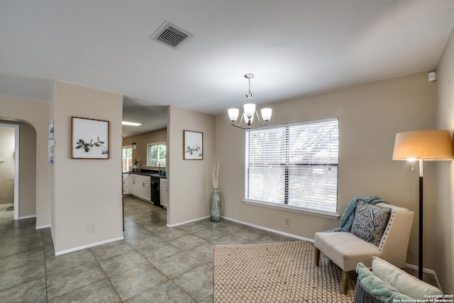 9838 Trendwood, San Antonio, TX 78250 - sitting room with arched walkways, a chandelier, baseboards, and light tile patterned floors