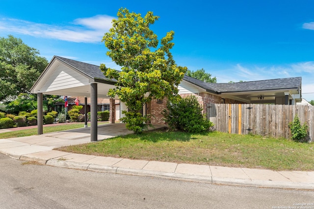 8907 Silver Bow, San Antonio, TX 78242 - view of front of house with a carport, brick siding, and concrete driveway