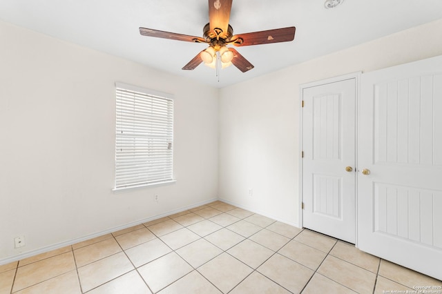 8907 Silver Bow, San Antonio, TX 78242 - unfurnished bedroom featuring light tile patterned floors, ceiling fan, baseboards, and a closet