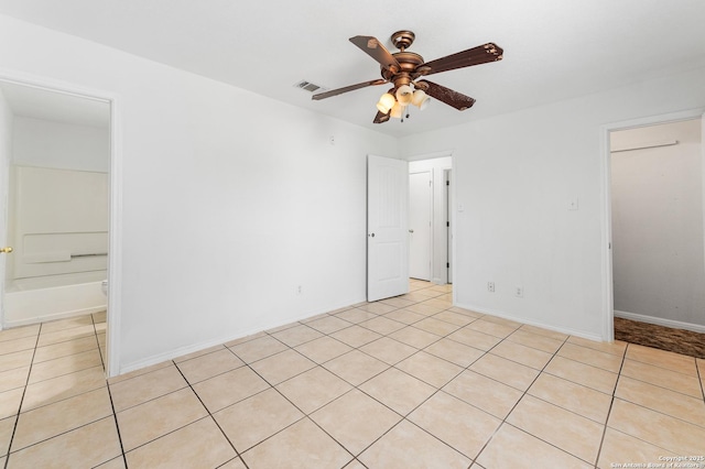 8907 Silver Bow, San Antonio, TX 78242 - spare room with ceiling fan, light tile patterned floors, and baseboards