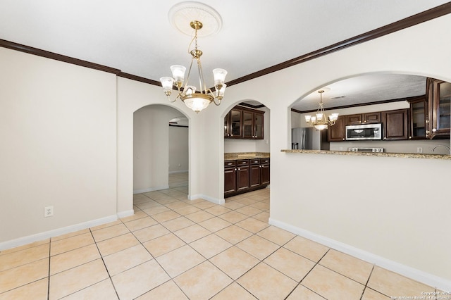 8907 Silver Bow, San Antonio, TX 78242 - kitchen with stainless steel appliances, a chandelier, dark brown cabinets, ornamental molding, and arched walkways