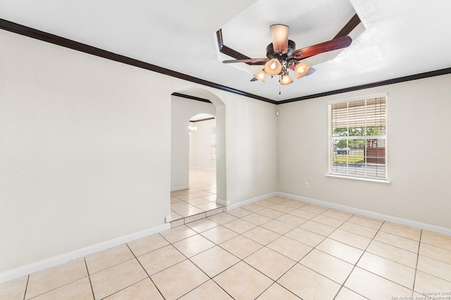 8907 Silver Bow, San Antonio, TX 78242 - spare room with arched walkways, a ceiling fan, ornamental molding, baseboards, and light tile patterned floors