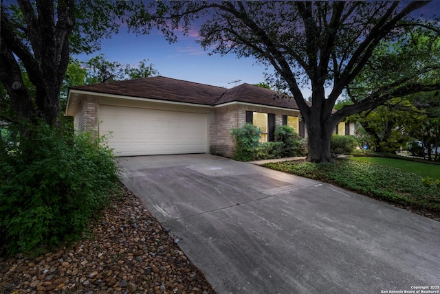 7927 Misty Park, San Antonio, TX 78250 - ranch-style home featuring concrete driveway, an attached garage, and brick siding