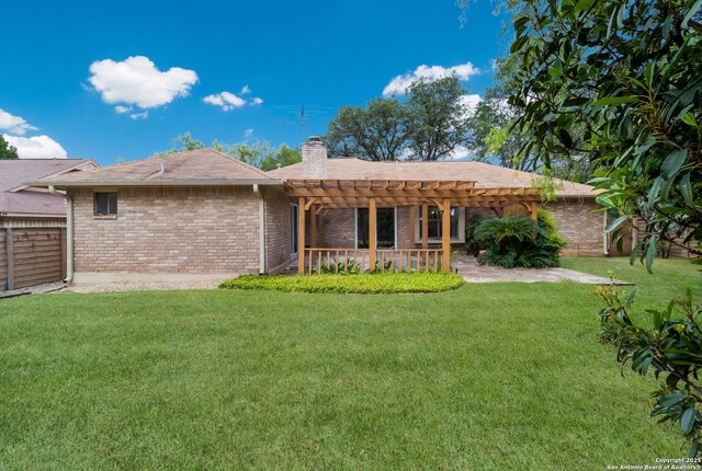 7927 Misty Park, San Antonio, TX 78250 - rear view of house featuring a pergola, a chimney, and brick siding