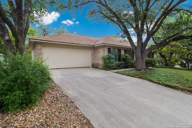 7927 Misty Park, San Antonio, TX 78250 - ranch-style home with brick siding, an attached garage, and concrete driveway