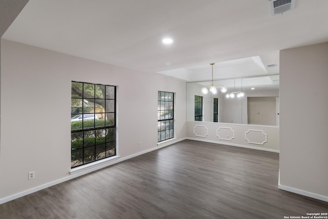7927 Misty Park, San Antonio, TX 78250 - empty room featuring a chandelier, a raised ceiling, dark wood-style flooring, and recessed lighting