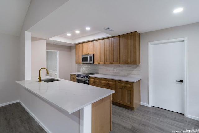 7927 Misty Park, San Antonio, TX 78250 - kitchen featuring stainless steel microwave, a sink, electric stove, wood finished floors, and recessed lighting