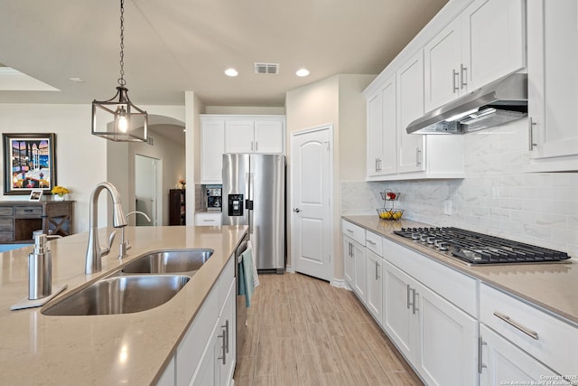 4610 Honeydew Rdg, San Antonio, TX 78253 - kitchen with under cabinet range hood, stainless steel appliances, a sink, white cabinetry, and recessed lighting