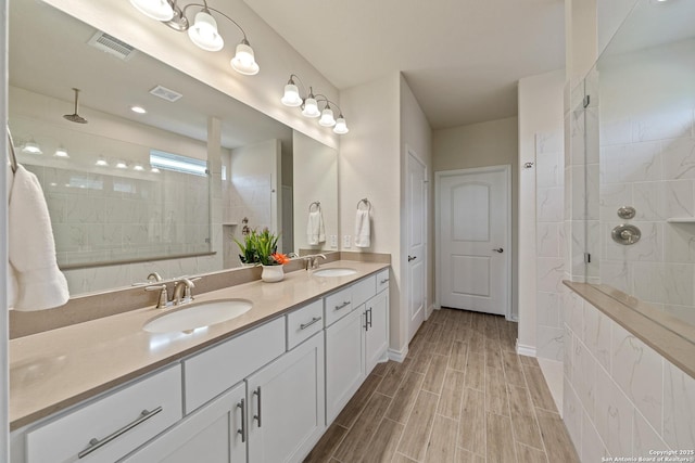 4610 Honeydew Rdg, San Antonio, TX 78253 - full bathroom featuring walk in shower, double vanity, wood tiled floors, and baseboards
