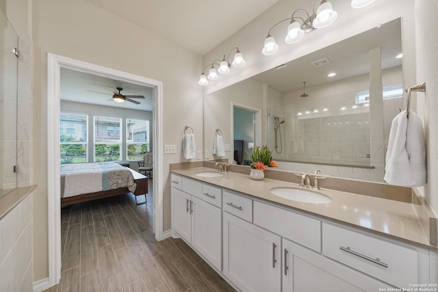 4610 Honeydew Rdg, San Antonio, TX 78253 - ensuite bathroom with a tile shower, double vanity, ceiling fan, wood finished floors, and baseboards
