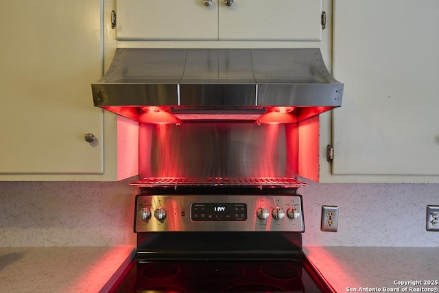 119 Janis Rae, San Antonio, TX 78201 - kitchen view of range hood, tasteful backsplash, and electric stove