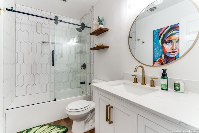 2111 Peach Blossom St, San Antonio, TX 78247 - bathroom with toilet, vanity, wood finished floors, and enclosed tub / shower combo
