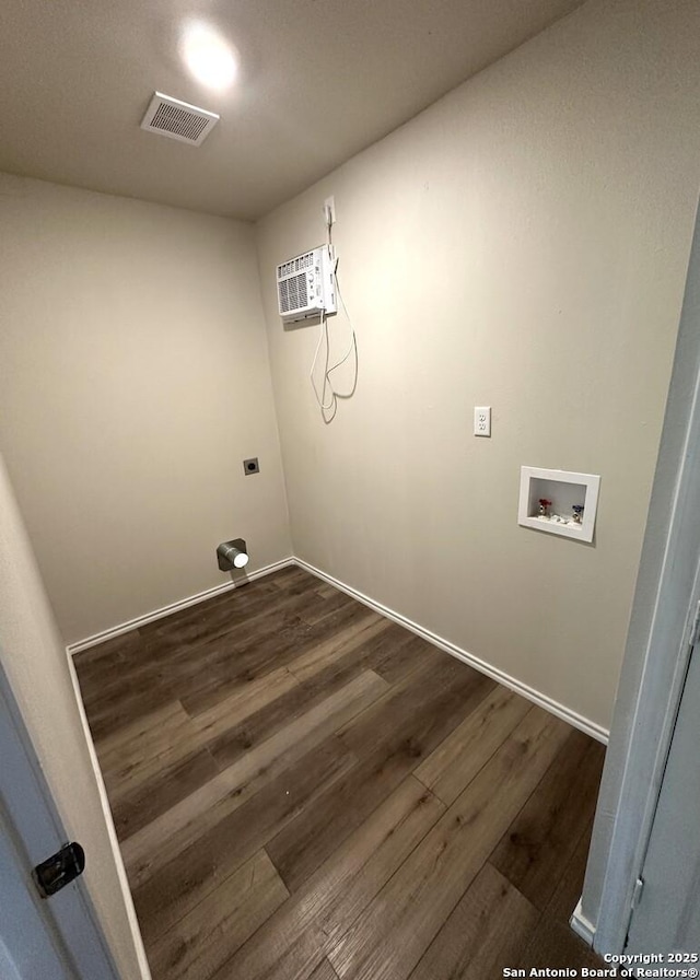 459 Maddux, San Antonio, TX 78227 - laundry area with washer hookup, a wall mounted AC, dark wood-style flooring, and baseboards