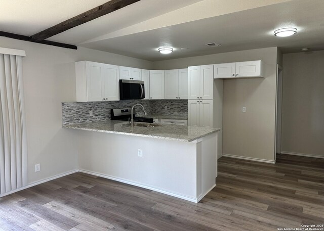 459 Maddux, San Antonio, TX 78227 - kitchen with stainless steel appliances, a peninsula, white cabinets, dark wood-type flooring, and beam ceiling