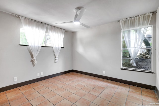 4207 Tallulah, San Antonio, TX 78218 - unfurnished room featuring healthy amount of natural light, ceiling fan, light tile patterned flooring, and baseboards