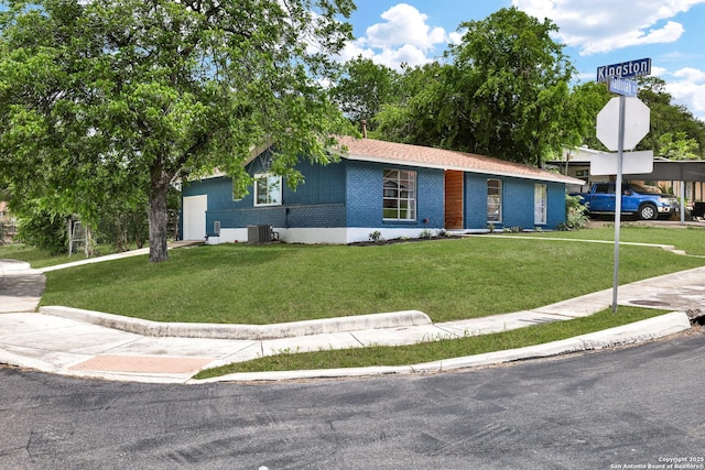 4207 Tallulah, San Antonio, TX 78218 - view of front of home featuring a front yard, brick siding, and cooling unit