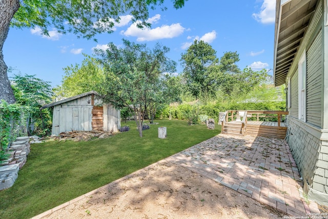 419 Wickes, San Antonio, TX 78210 - view of grassy yard featuring a patio area, an outbuilding, and a wooden deck