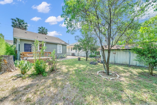 419 Wickes, San Antonio, TX 78210 - view of grassy yard featuring a wooden deck and an outbuilding