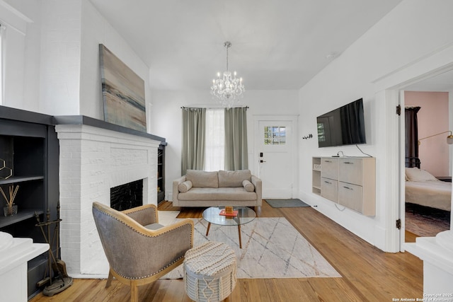419 Wickes, San Antonio, TX 78210 - living room featuring a chandelier, wood finished floors, and a fireplace