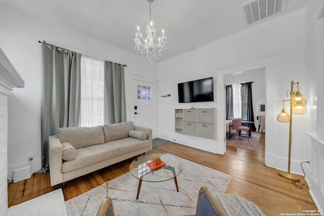 419 Wickes, San Antonio, TX 78210 - living room with a chandelier, wood finished floors, and baseboards