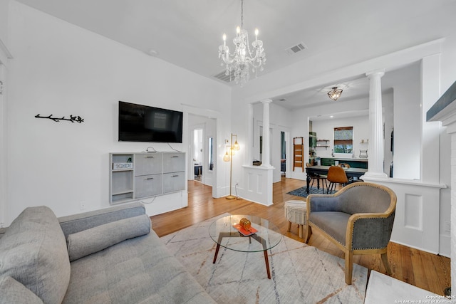 419 Wickes, San Antonio, TX 78210 - living area featuring decorative columns, light wood-type flooring, and a chandelier