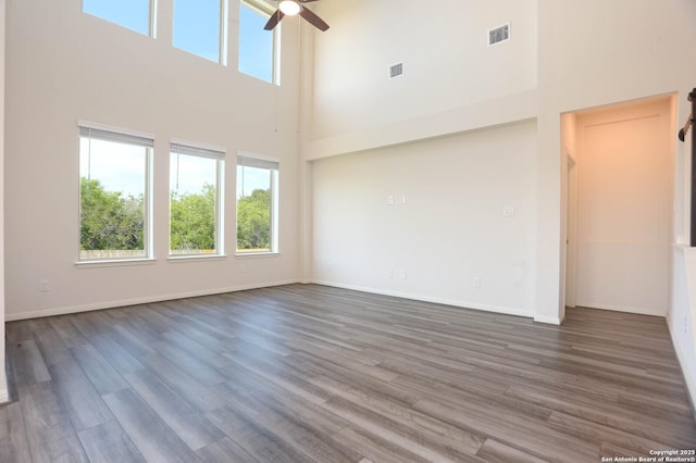 9569 Witten Dr, San Antonio, TX 78254 - unfurnished room with a high ceiling, a ceiling fan, wood finished floors, and baseboards