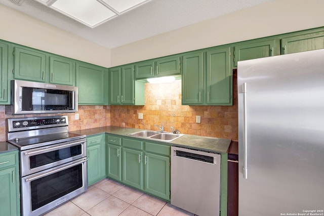 1314 Acorn, Hondo, TX 78861 - kitchen with stainless steel appliances, a sink, tasteful backsplash, and light tile patterned floors